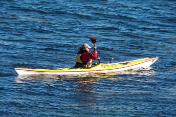 kayaker paddling in away